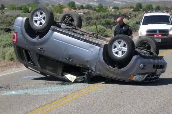 A picture of an SUV that had rolled over.