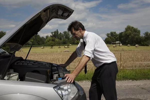 Man looking at the car's engine