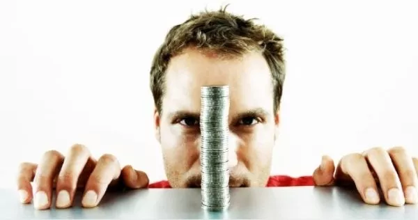A picture of a man staring at money.
