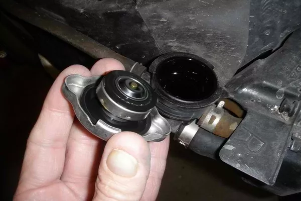 Disconnect the radiator by removing the radiator cap Removing the radiator cap