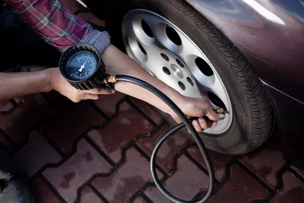 Man monitoring tire pressure