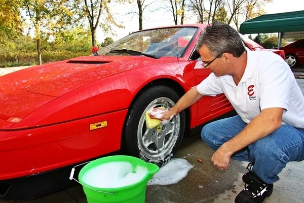 man cleaning the wheels of the car