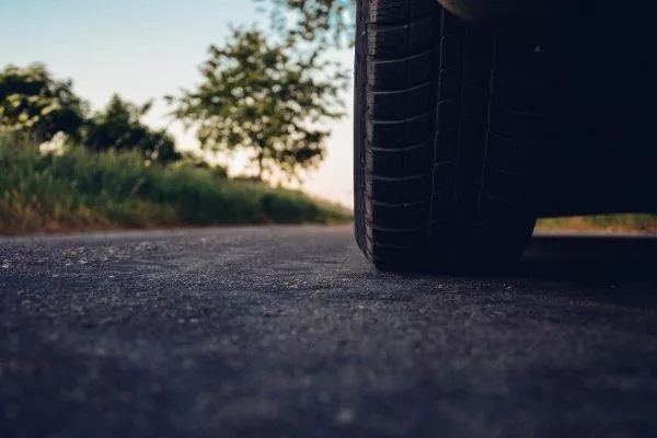 A tire of a car under a sunset