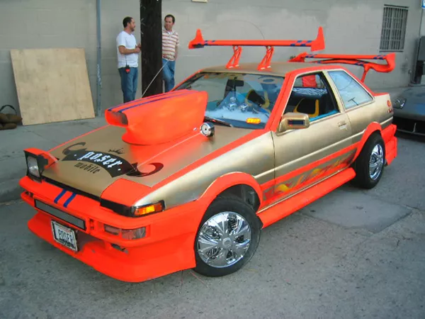 An overly modified Toyota AE86 parked and being shown off.