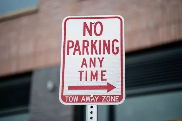 Follow traffic rules at all times to avoid getting your car towed A pickup truck getting towed