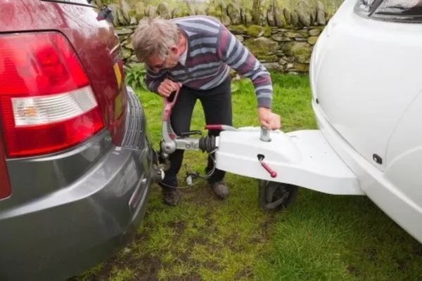 Man towing a vehicle