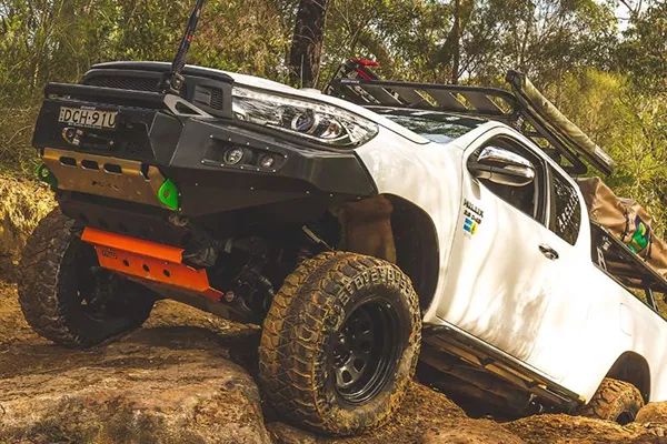 A kitted out 2017 Toyota Hilux 4x4 doing some gnarly climbs A picture of the Toyota Hilux 4x4 climbing rough terrain