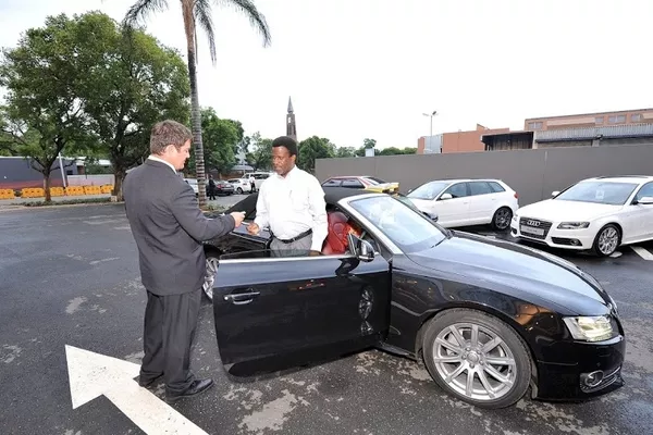 two man talking outside the car
