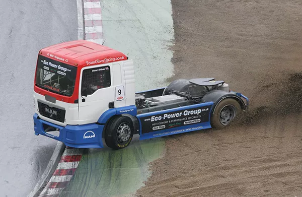 A truck oversteers into the side of a road during a truck race event.
