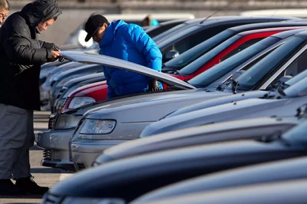 man checking under the hood