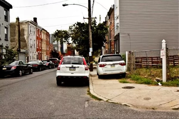 Cars double parked and on the side walk