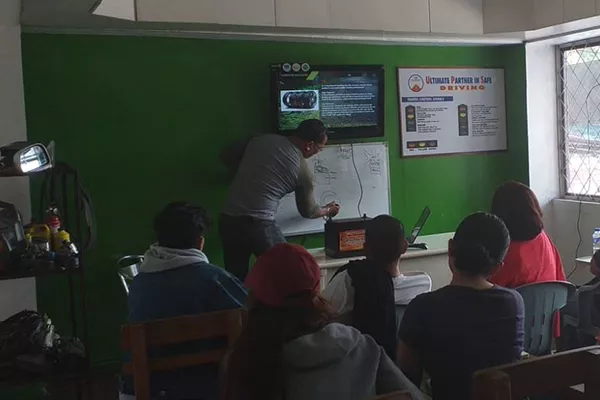 A UPS driving school Baguio branch instructor giving a lecture to student drivers A picture of a UPS driving school instructor giving a lecture