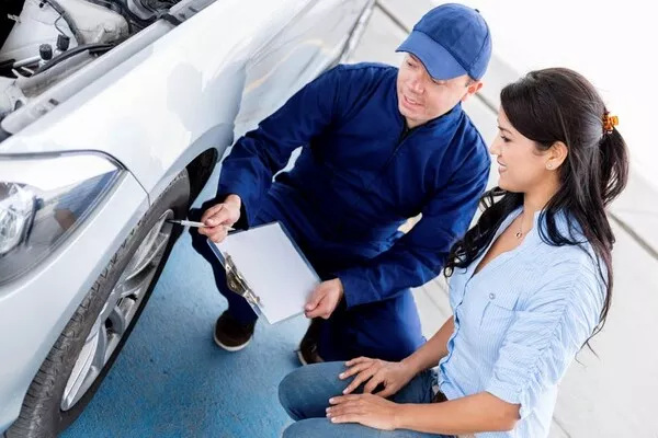 Woman talking to a mechanic