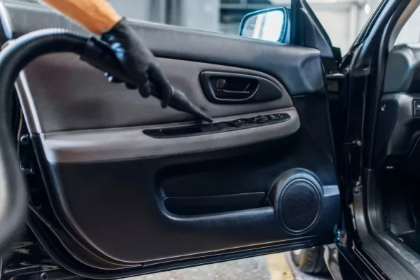 Vacuuming is a very useful and handy way of cleaning your car M vacuuming a car door