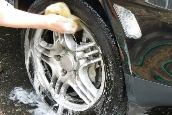 If you can't reach those tight, hidden spots with a brush, go get 'em with your hands A guy washing his wheels