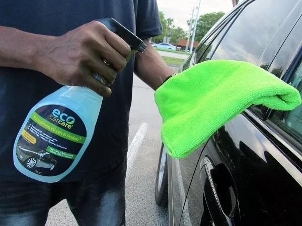 Man spraying the microfiber towel