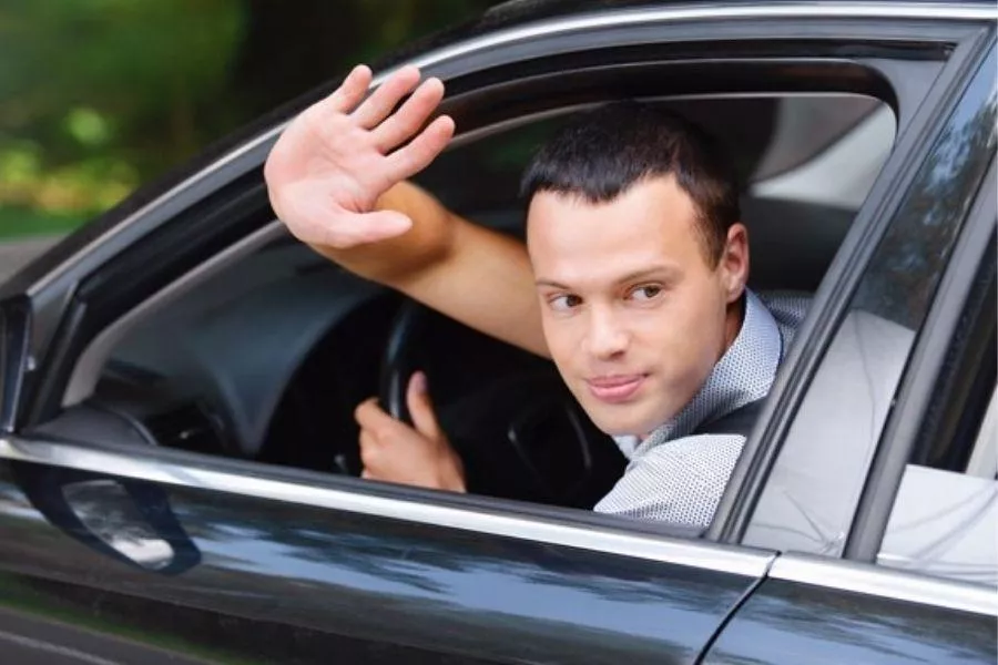 It is common to encounter and/or commit right of way mistakes. But apologizing for it is rarer still A picture of a driving waving