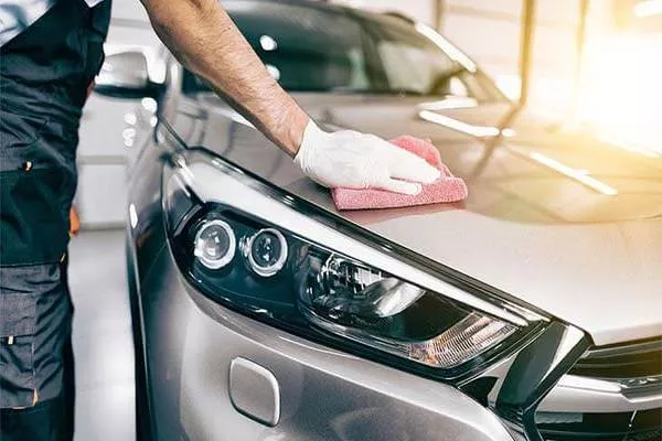 Polish and wax complement each other and can provide amazing results when used together to achieve peak car shine Man wiping the car's interior