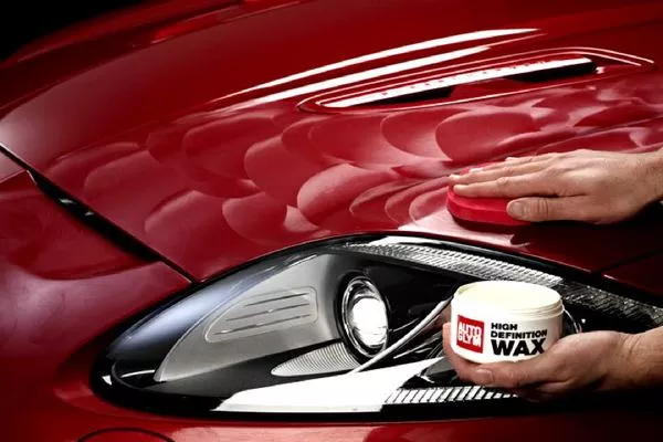 Solvents, colorants, and UV inhibitors are also added to many waxes aside from carnauba wax to maximize protection Man waxing the car