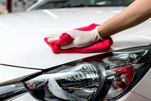 A washed and waxed car restores pride of ownership. Doing it on your own will elevate you further A man waxing a car