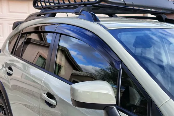 White car with wind deflectors