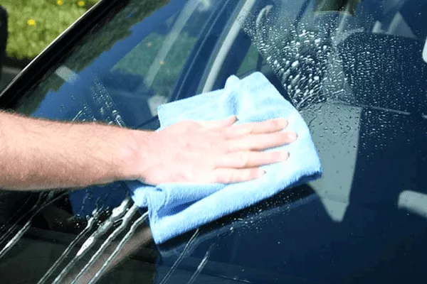 Clean the outside first to help you clean the inside better Cleaning a windshield
