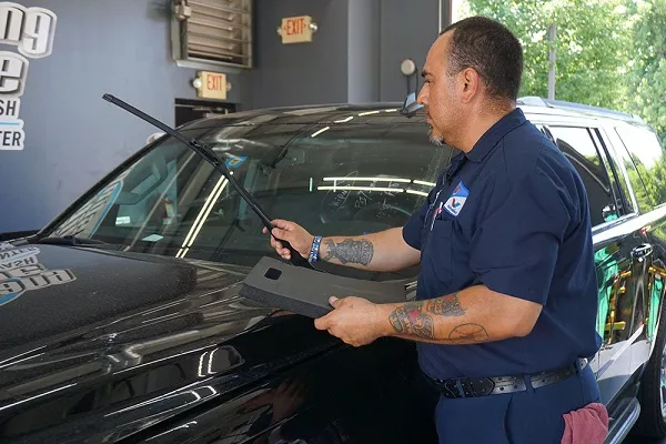 Man inspecting the windshield wiper