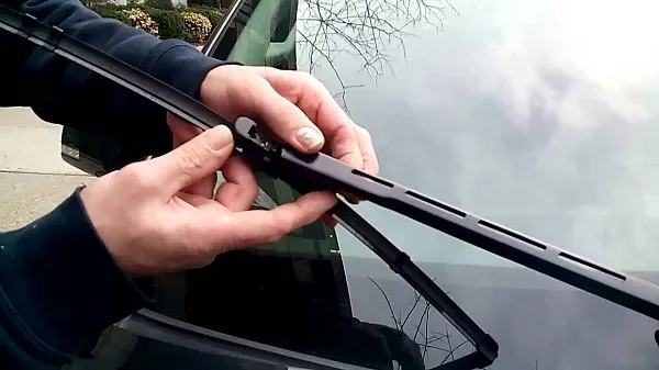 Man holding the windshield wiper