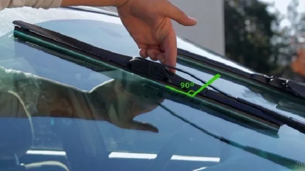 Man checking the angle of the windshield wiper