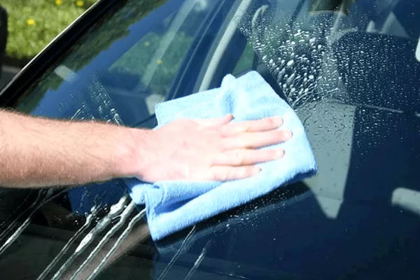 Man cleaning the windshield