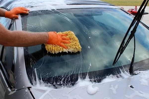 Man cleaning the windshield