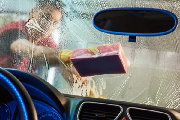 Man cleaning the windshield
