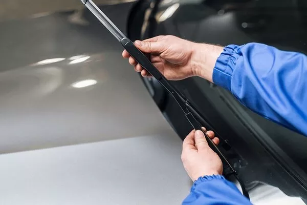 Man holding a windshield wiper