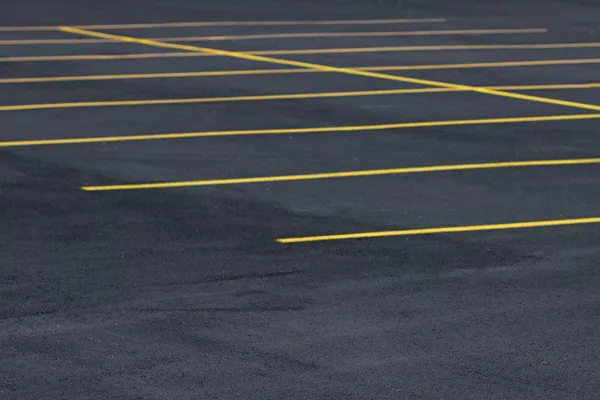 Park within the yellow lines and no one will think you're a douche. A picture of parking lot markings.