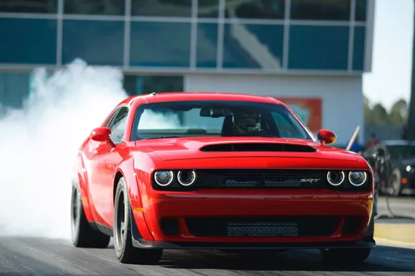 A picture of a dodge demon doing a burnout