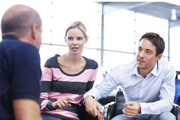 a couple negotiating with an agent
