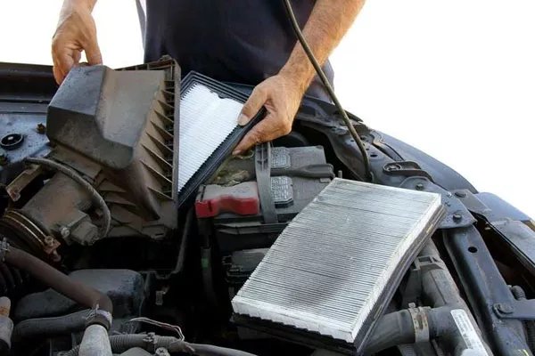 Clean air filters will allow your engine to breathe easily and not have a hard time running a man checking and replacing air filter