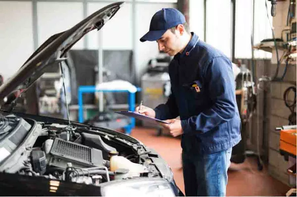 a mechanic doing checking a car