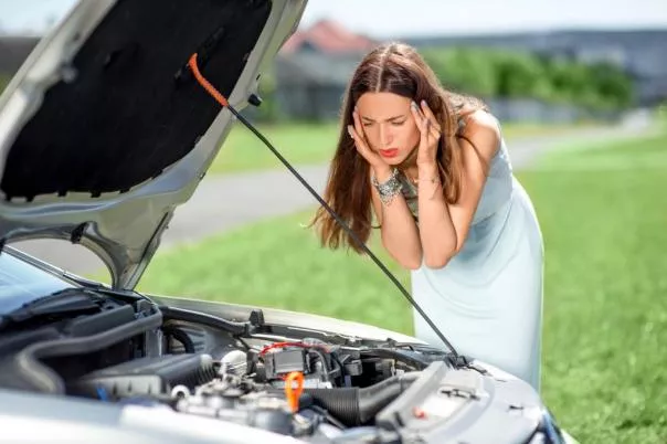 A girl with her car engine's problem