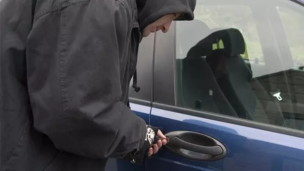 a car theft trying to unlock a car