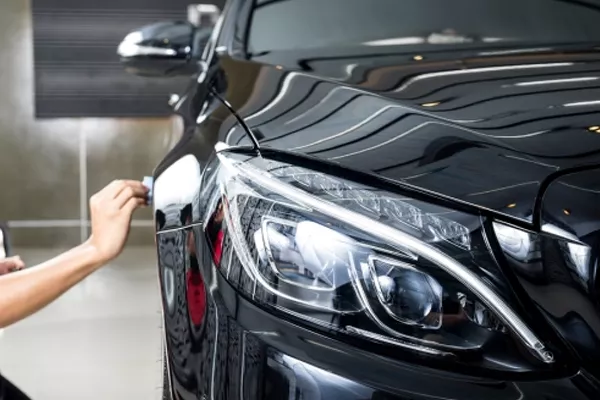 A guy polishing a car