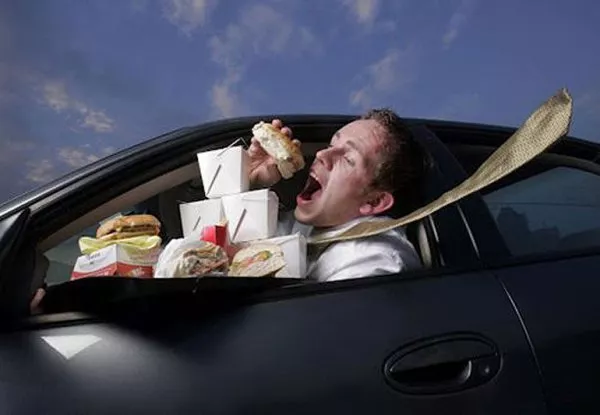 a men eating while driving
