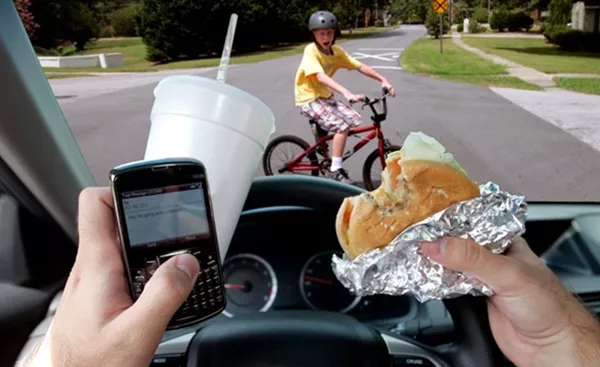 eating while driving with a kid in front of the car