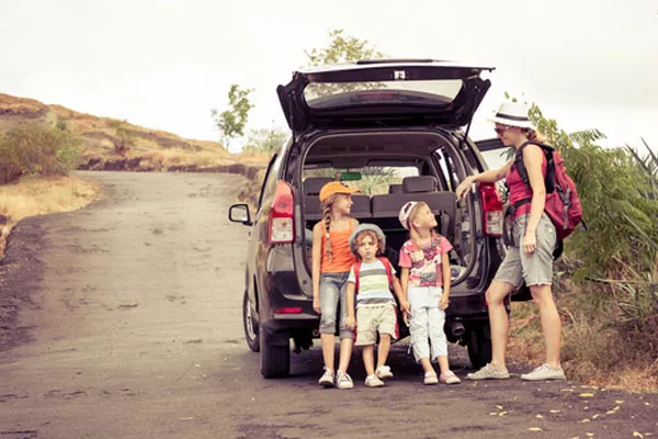 family with their car out on a roadtrip