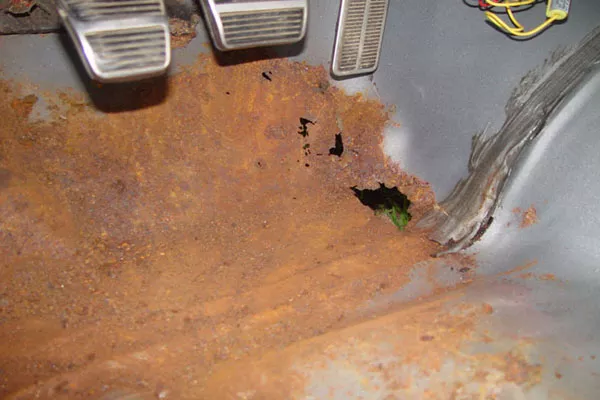 Rust on the car floor can make the metal brittle and can cause holes Rust on a car floor