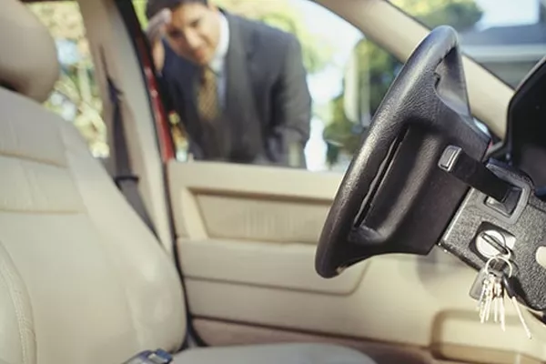A man looking into a car