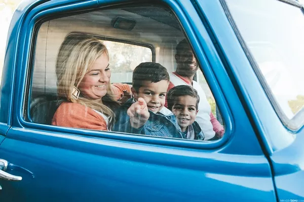 A pickup truck can fit a small family inside pickup and family