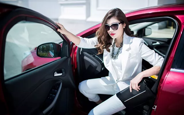 Be extra cautious on the road A woman in white clothes getting out of a red car