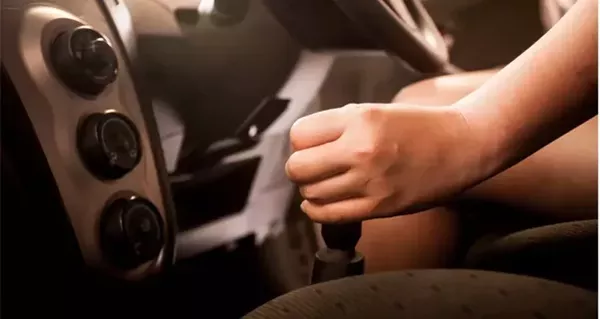 Person driving with a stick shift