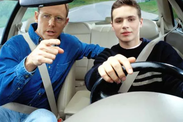 Father instructs his son to drive a car